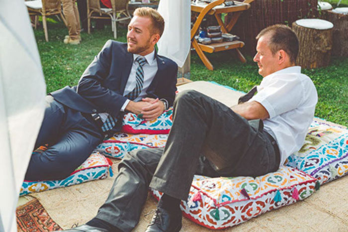 Veranstaltungsort Gärtnerei Decher, Karben Zwei Männer mit Anzug entspannt auf Sitzkissen
